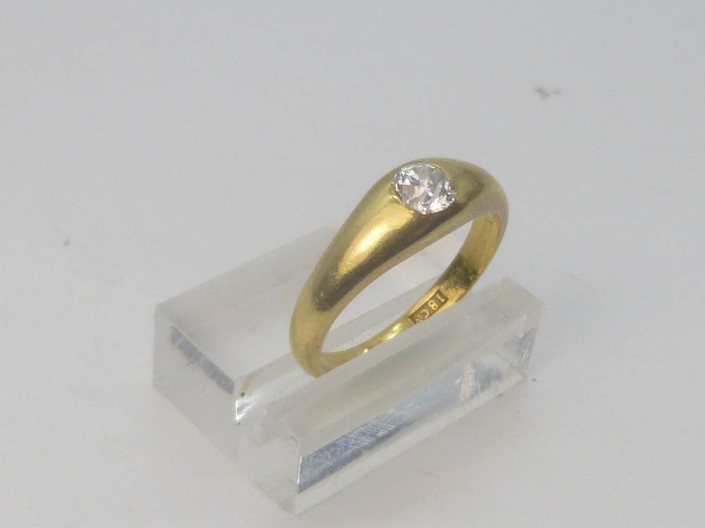 A Victorian 18ct yellow gold gypsy ring featuring a centrally inset round diamond within a smooth tapered band.