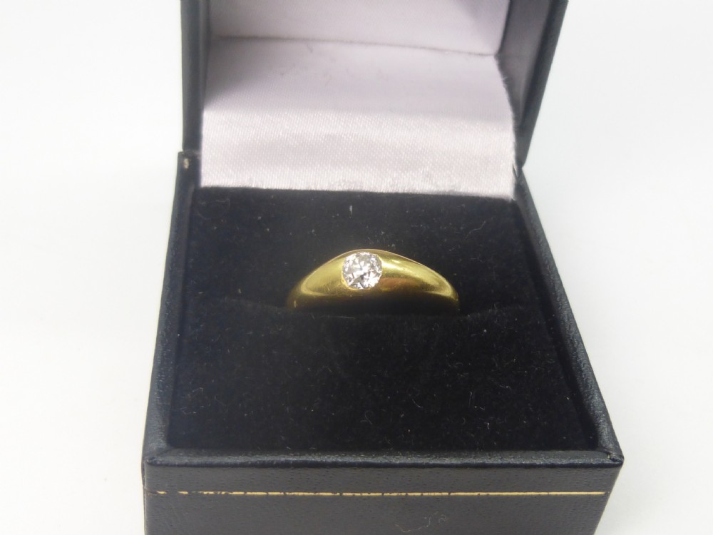 A Victorian 18ct yellow gold gypsy ring featuring a centrally inset round diamond within a smooth tapered band. View II