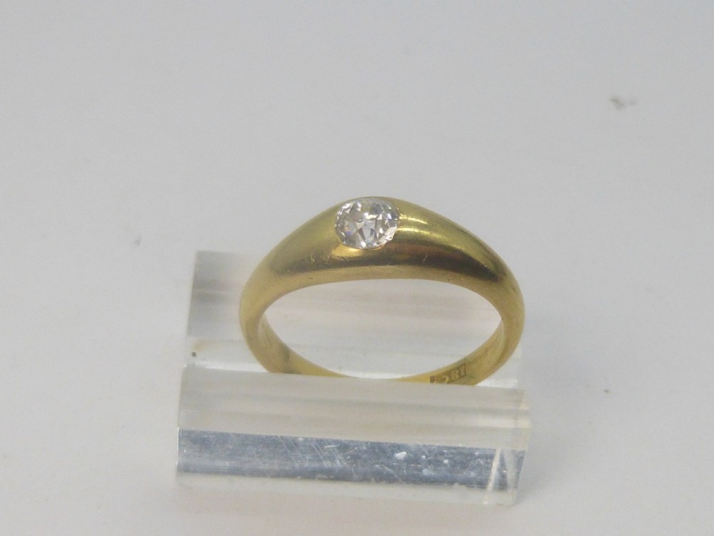 A Victorian 18ct yellow gold gypsy ring featuring a centrally inset round diamond within a smooth tapered band. View V