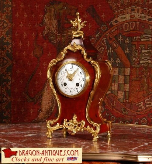 Ormolu and Red Veneer Boudoir Table Clock 
By Samuel Marti.