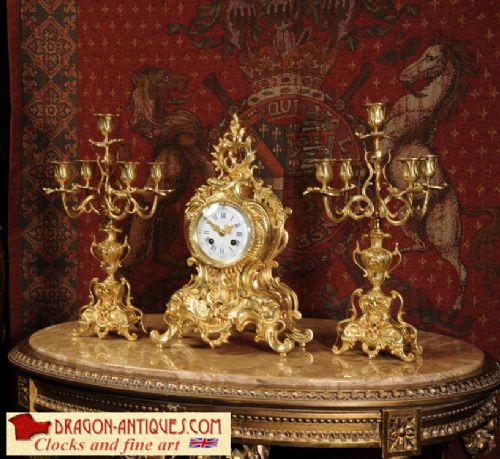 Rococo Antique French Gilt Brass Clock Set
by A. D. Mougin