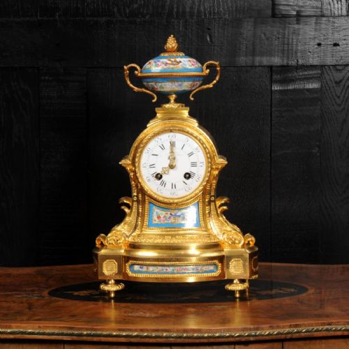 fig 1. An antique French ormolu mantel clock featuring hand-painted turquoise porcelain panels and a porcelain urn finial atop a gilded bronze case.