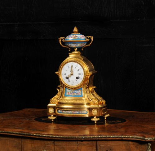 fig 2. An antique French ormolu mantel clock featuring hand-painted turquoise porcelain panels and a porcelain urn finial atop a gilded bronze case.