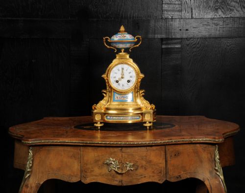 fig 4. An antique French ormolu mantel clock featuring hand-painted turquoise porcelain panels and a porcelain urn finial atop a gilded bronze case.