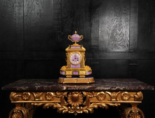 fig 8. An ornate French gilt bronze and lilac hand-painted porcelain mantel clock featuring a decorative urn finial and fluted side columns.