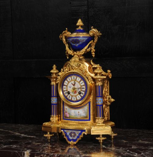 fig 1. A Louis XVI style French ormolu and cobalt blue hand-painted porcelain mantel clock topped with an urn finial.
