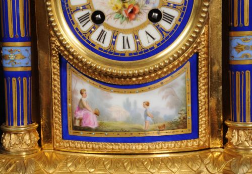 fig 4. A Louis XVI style French ormolu and cobalt blue hand-painted porcelain mantel clock topped with an urn finial.