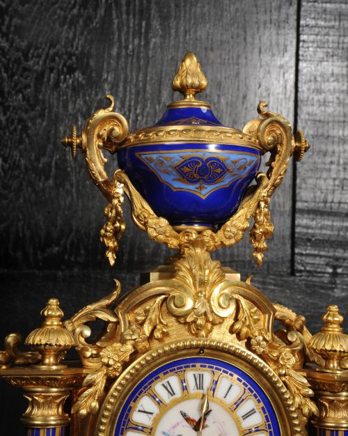 fig 5. A Louis XVI style French ormolu and cobalt blue hand-painted porcelain mantel clock topped with an urn finial.