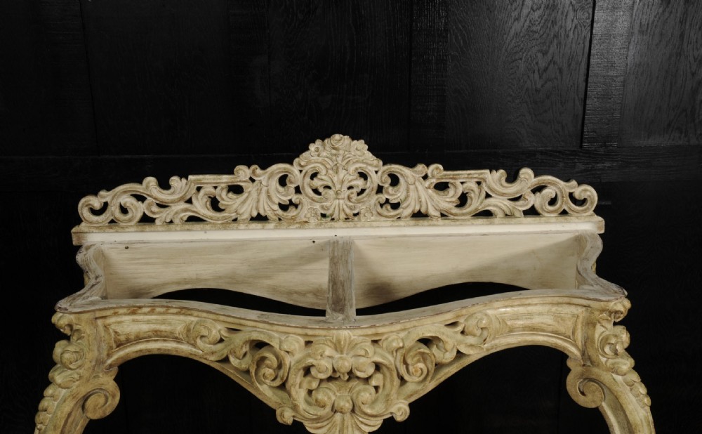 A carved off-white Rococo console table featuring a white marble top, scrolled cabriole legs, and detailed acanthus leaf motifs. View XI