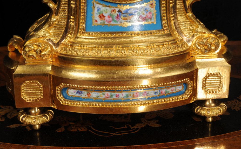 An antique French ormolu mantel clock featuring hand-painted turquoise porcelain panels and a porcelain urn finial atop a gilded bronze case. View XXII
