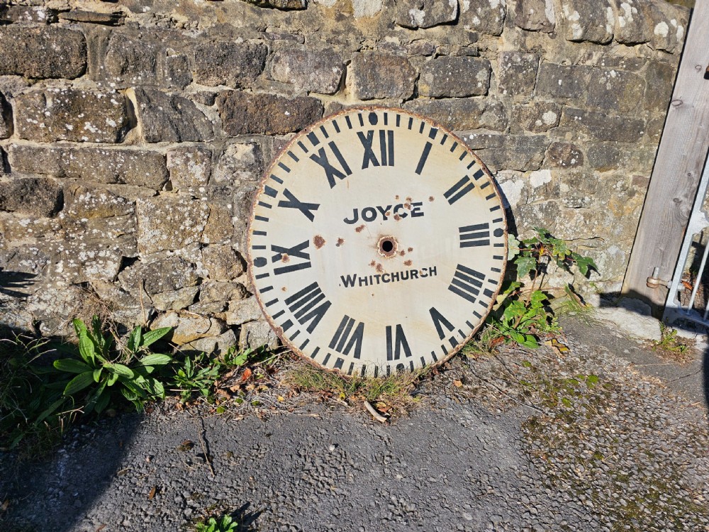 A large circular off-white enamelled turret clock dial featuring black Roman numerals and the maker name Joyce Whitchurch. View II