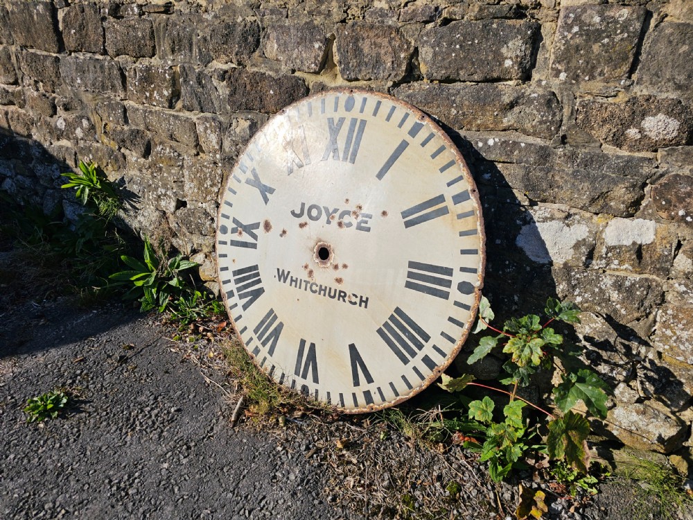 A large circular off-white enamelled turret clock dial featuring black Roman numerals and the maker name Joyce Whitchurch. View III
