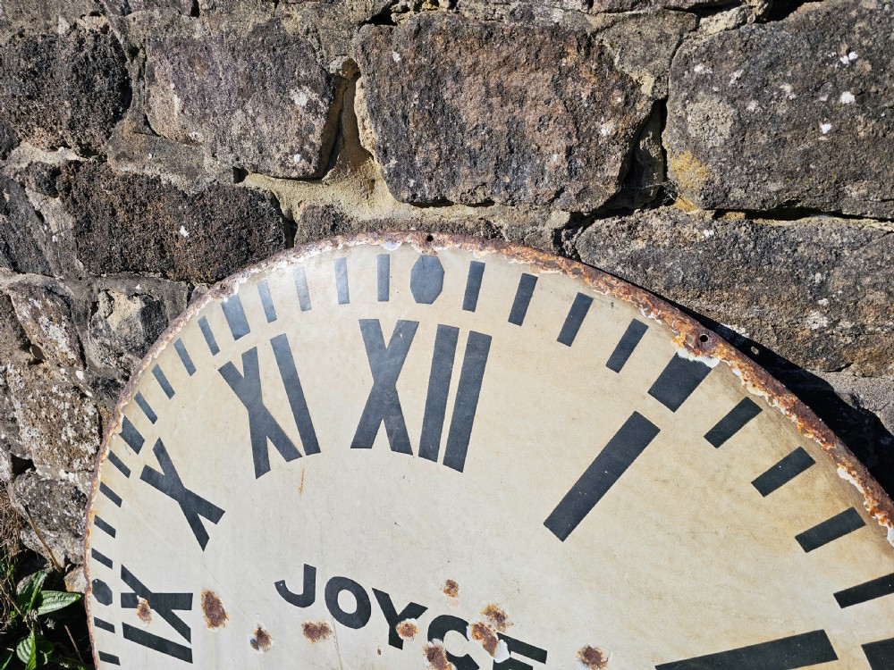 A large circular off-white enamelled turret clock dial featuring black Roman numerals and the maker name Joyce Whitchurch. View V
