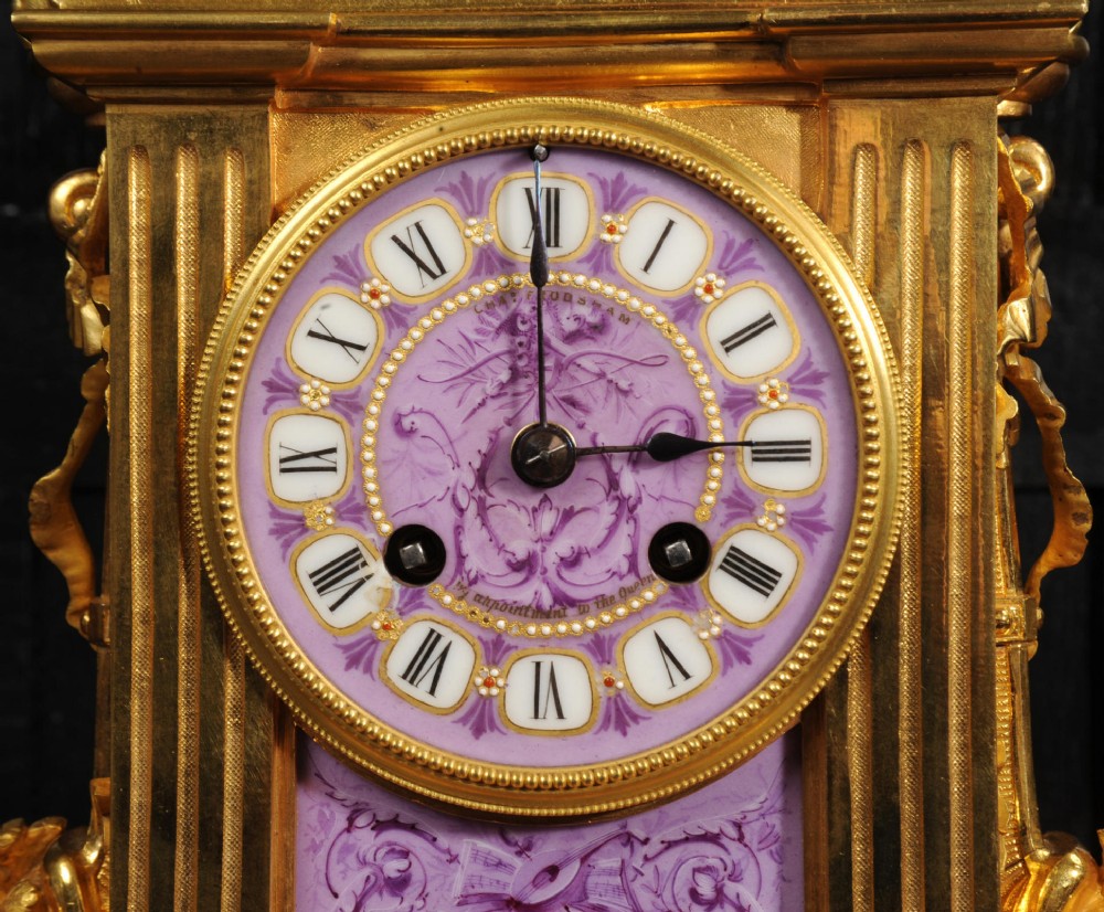An ornate French gilt bronze and lilac hand-painted porcelain mantel clock featuring a decorative urn finial and fluted side columns. View VIII