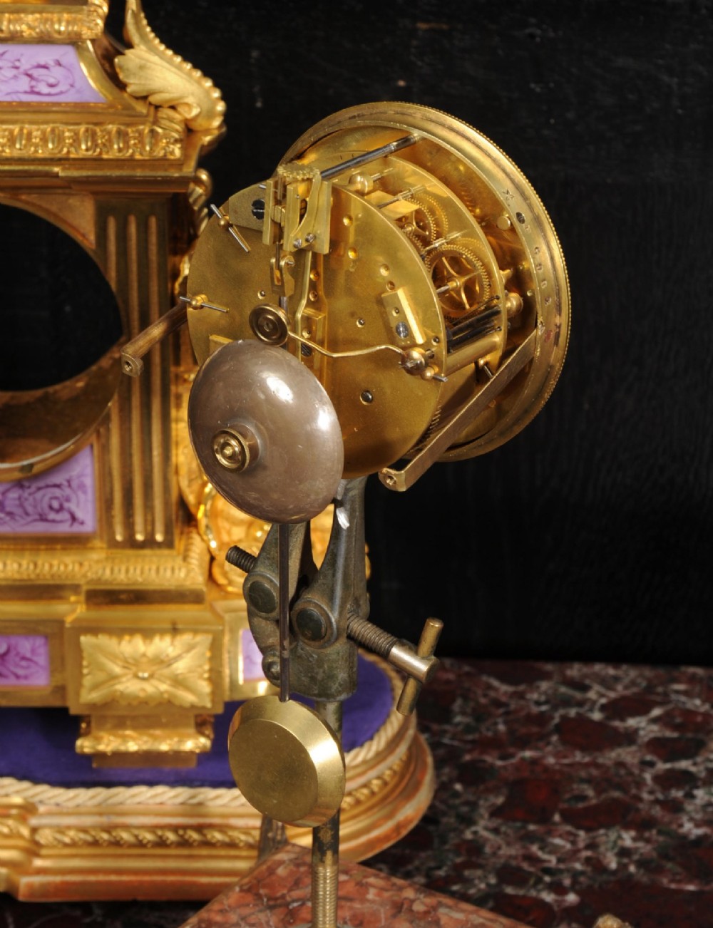 An ornate French gilt bronze and lilac hand-painted porcelain mantel clock featuring a decorative urn finial and fluted side columns. View XIII