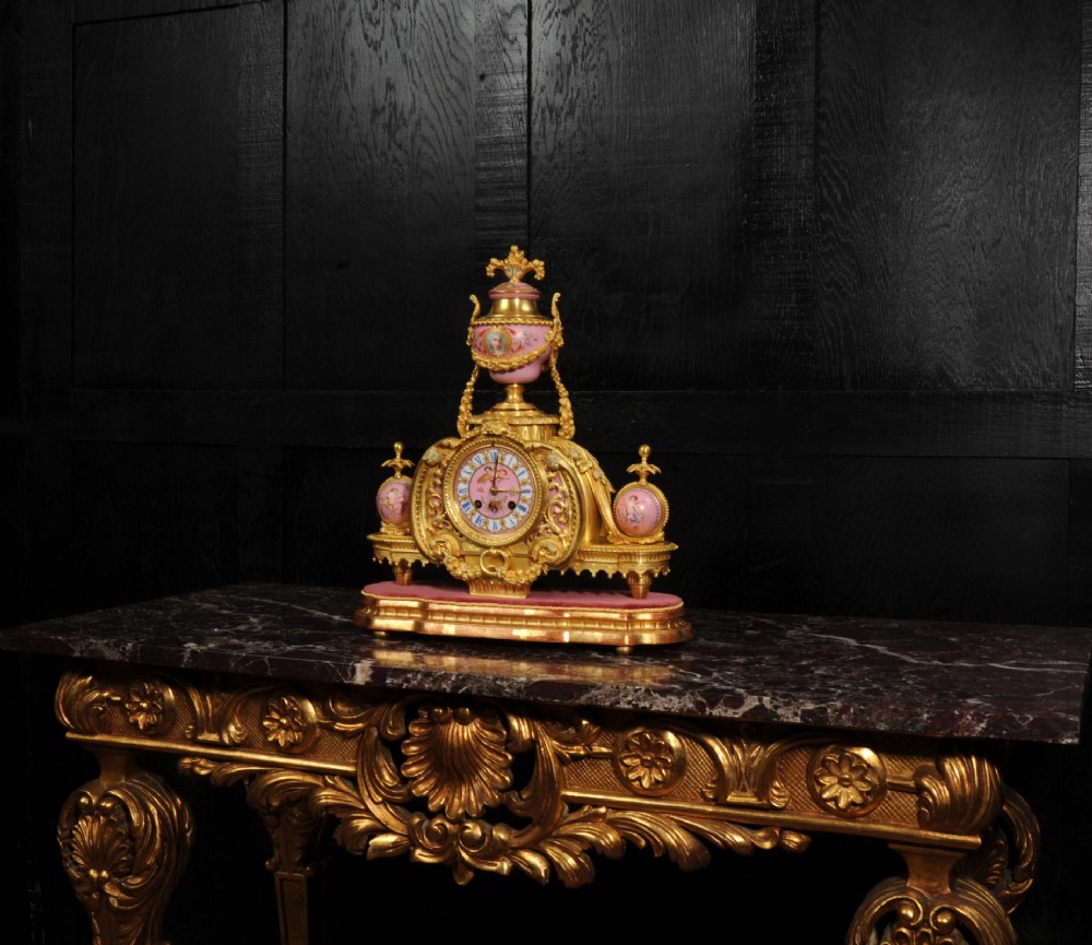 An ornate 19th-century French gilt-bronze and pink Sevres porcelain mantel clock featuring scrolled ormolu mounts and hand-painted cherubs. View III