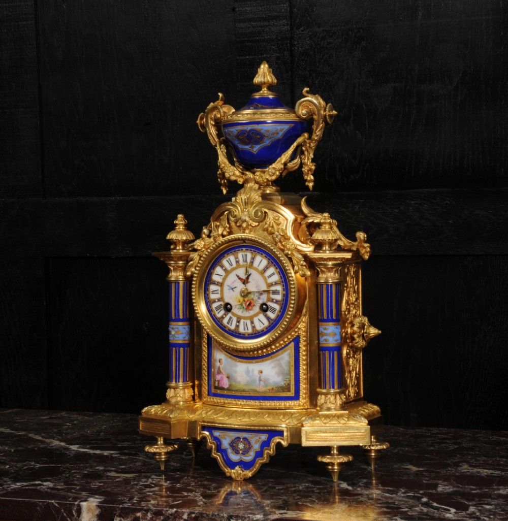 A Louis XVI style French ormolu and cobalt blue hand-painted porcelain mantel clock topped with an urn finial. View II