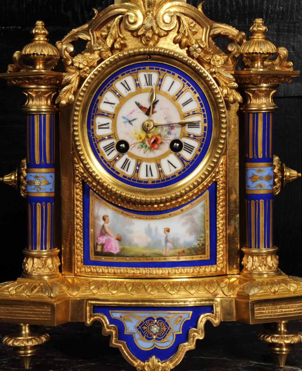 A Louis XVI style French ormolu and cobalt blue hand-painted porcelain mantel clock topped with an urn finial. View IV