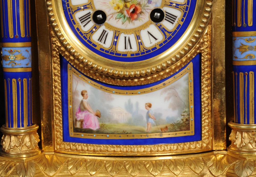 A Louis XVI style French ormolu and cobalt blue hand-painted porcelain mantel clock topped with an urn finial. View V