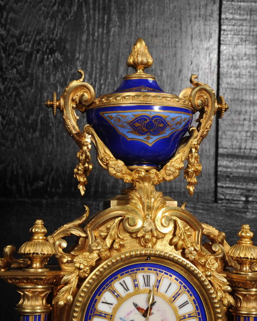 A Louis XVI style French ormolu and cobalt blue hand-painted porcelain mantel clock topped with an urn finial. View VI