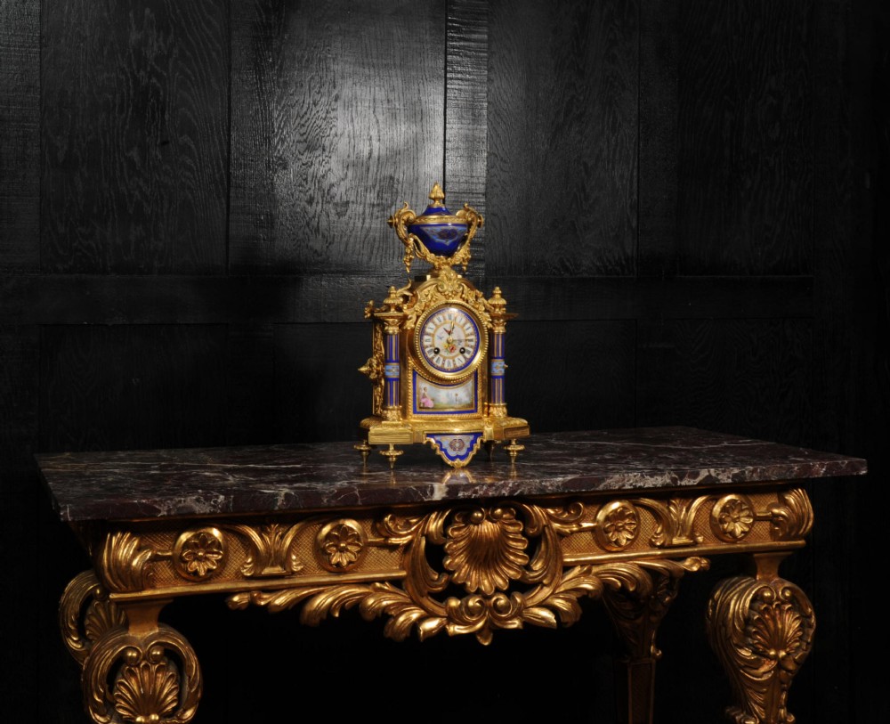 A Louis XVI style French ormolu and cobalt blue hand-painted porcelain mantel clock topped with an urn finial. View VII