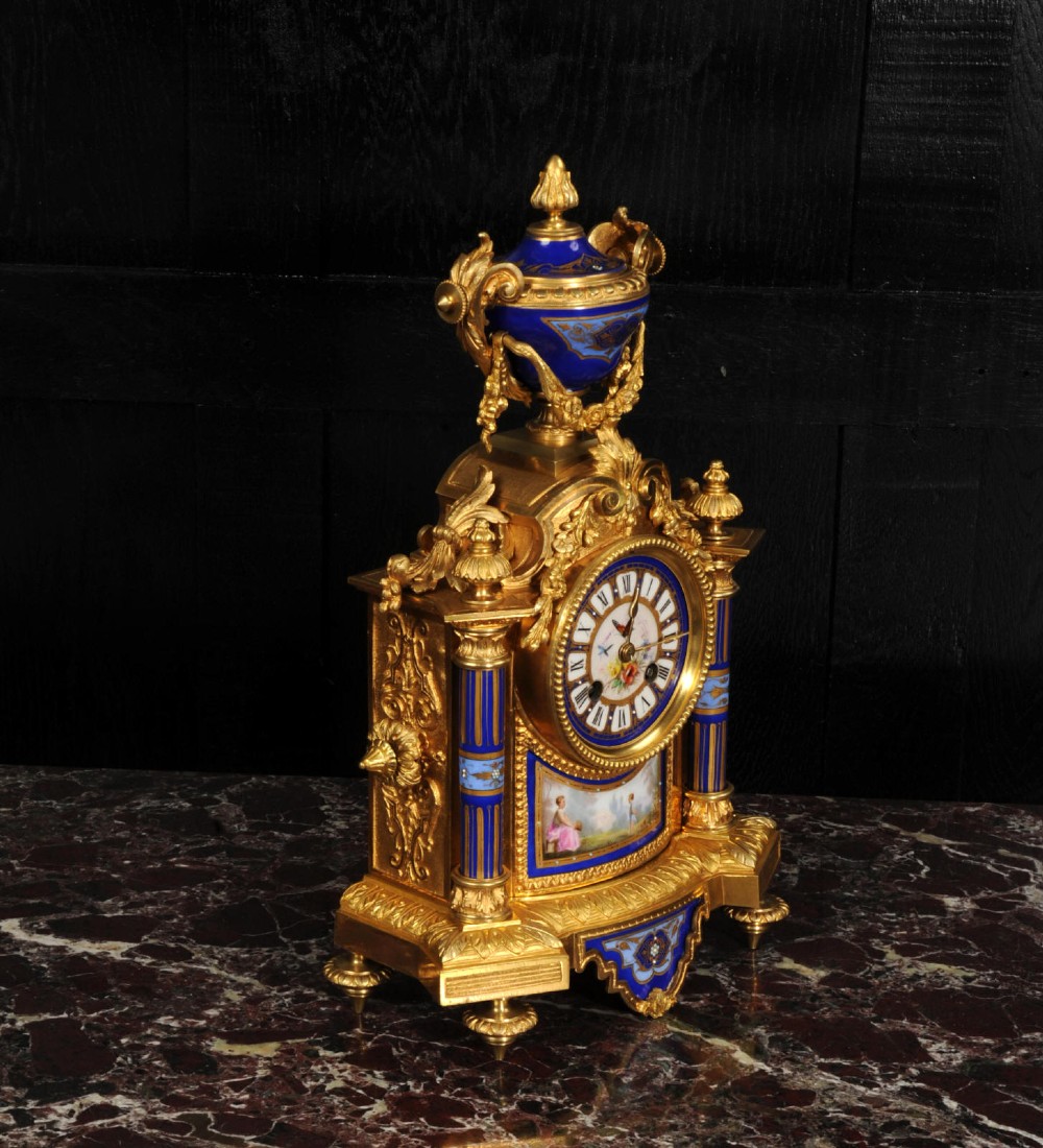 A Louis XVI style French ormolu and cobalt blue hand-painted porcelain mantel clock topped with an urn finial. View VIII