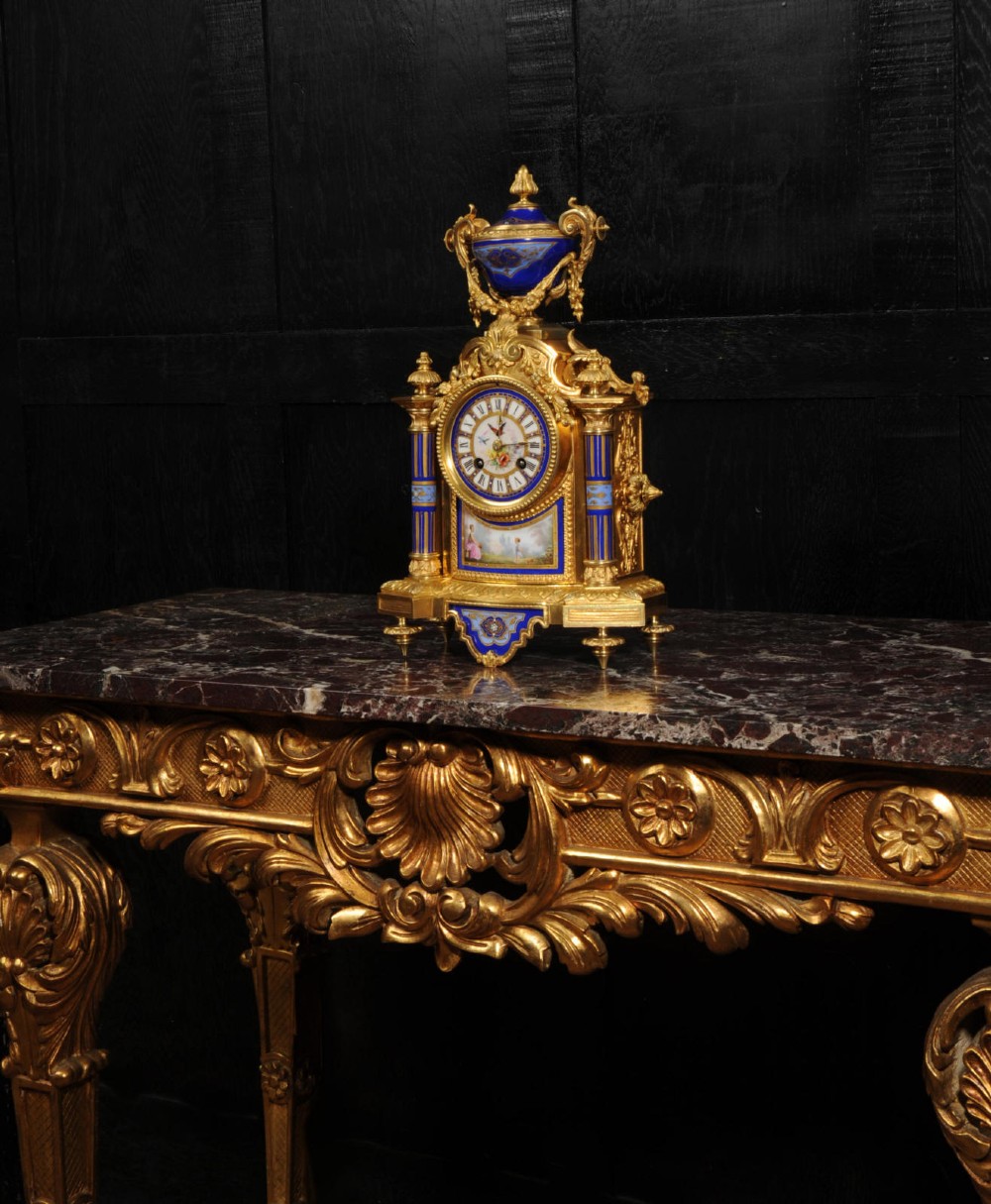 A Louis XVI style French ormolu and cobalt blue hand-painted porcelain mantel clock topped with an urn finial. View IX