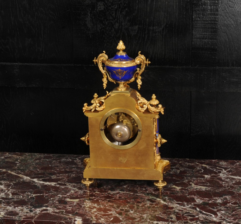 A Louis XVI style French ormolu and cobalt blue hand-painted porcelain mantel clock topped with an urn finial. View XIV