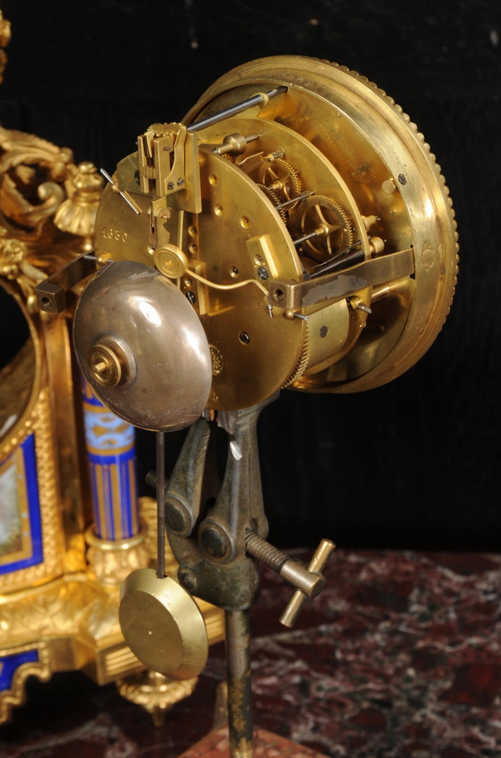 A Louis XVI style French ormolu and cobalt blue hand-painted porcelain mantel clock topped with an urn finial. View XV