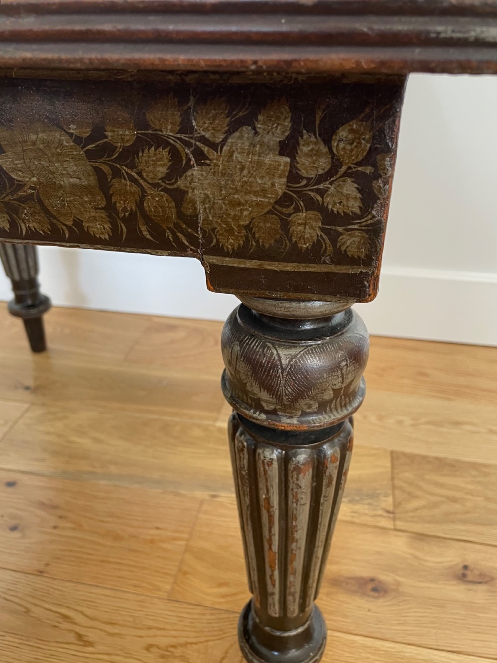 A square dark wood Anglo-Indian side table featuring carved floral friezes and bold fluted turned legs. View III