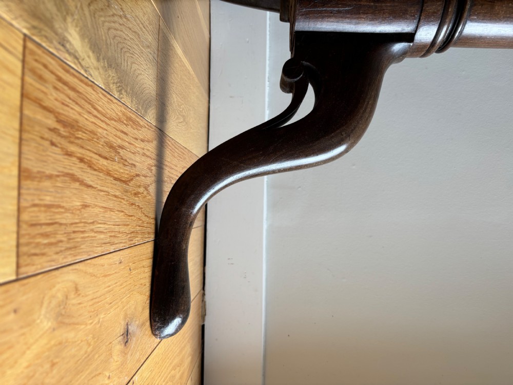 A circular Scottish George II mahogany occasional table featuring a single-piece turned pedestal column set on three cabriole legs with pad feet. View V