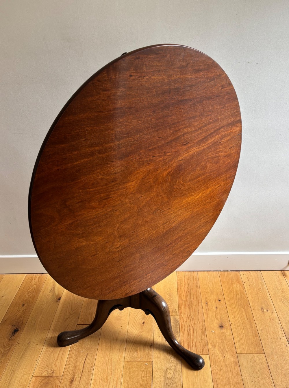A circular Scottish George II mahogany occasional table featuring a single-piece turned pedestal column set on three cabriole legs with pad feet. View VI