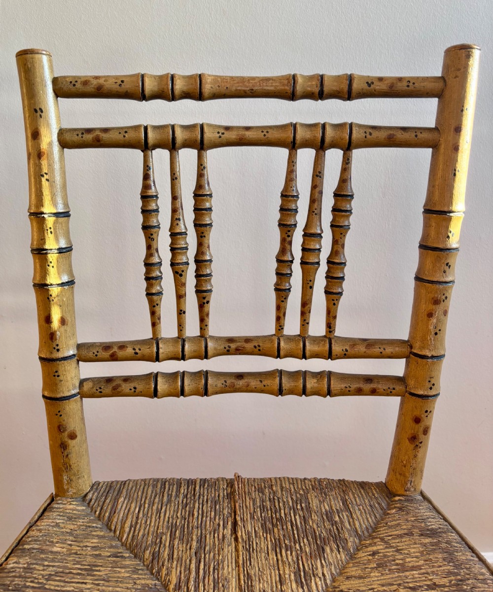 A pair of Regency-style side chairs with painted faux-bamboo wooden frames and woven rush seats. View II
