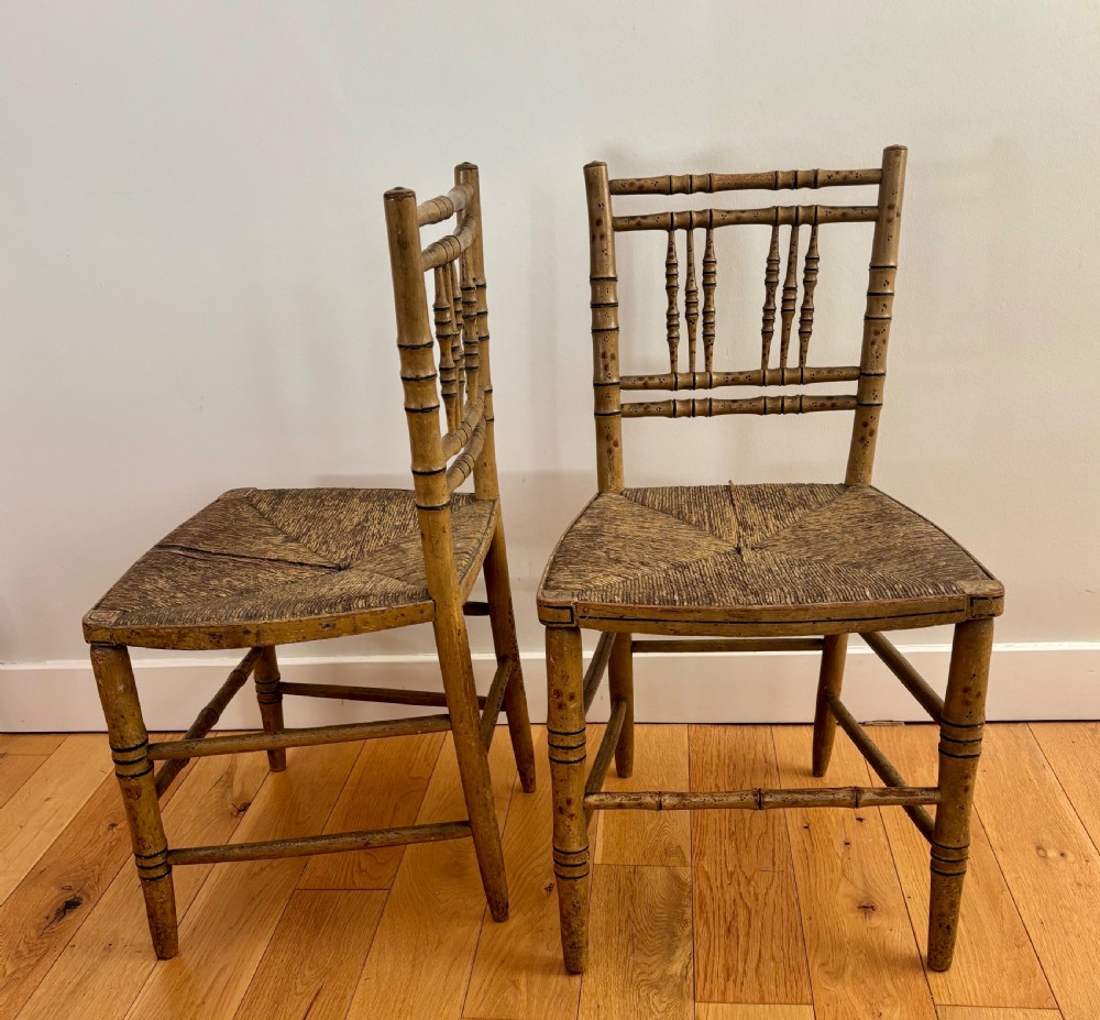 A pair of Regency-style side chairs with painted faux-bamboo wooden frames and woven rush seats. View V
