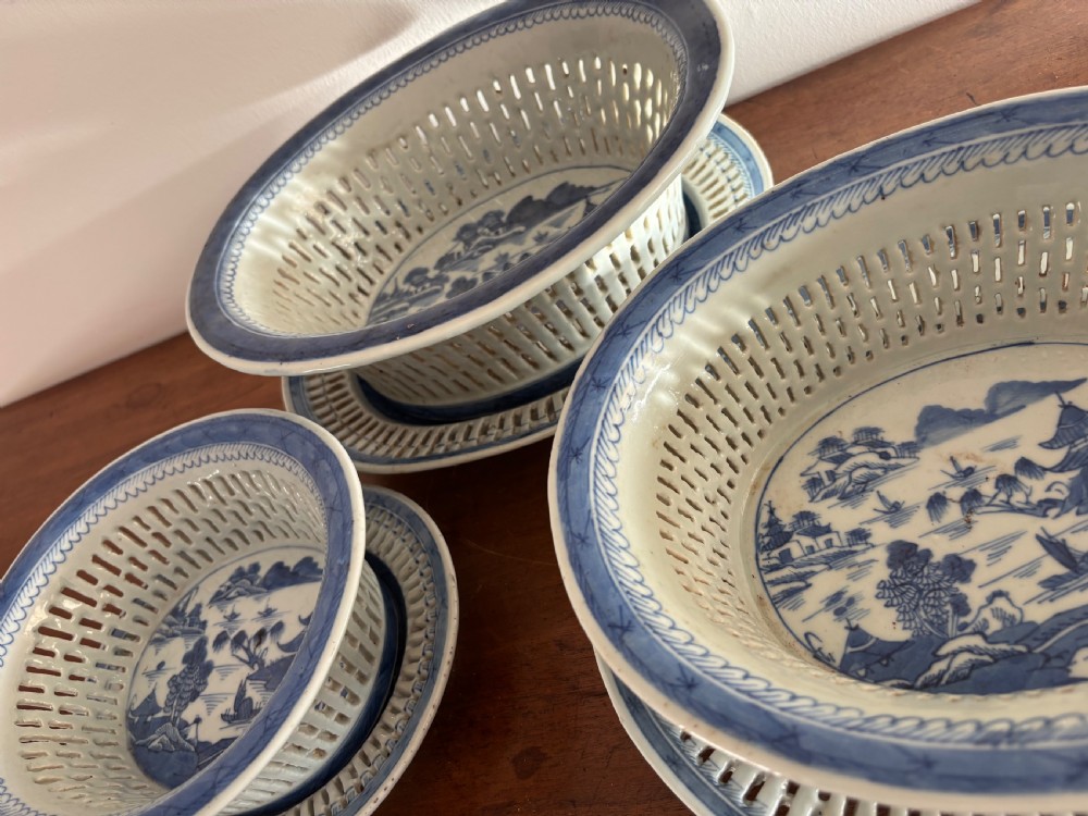 A set of three Chinese export blue and white porcelain reticulated baskets resting on matching pierced undertrays with hand-painted river landscape scenes. View IV