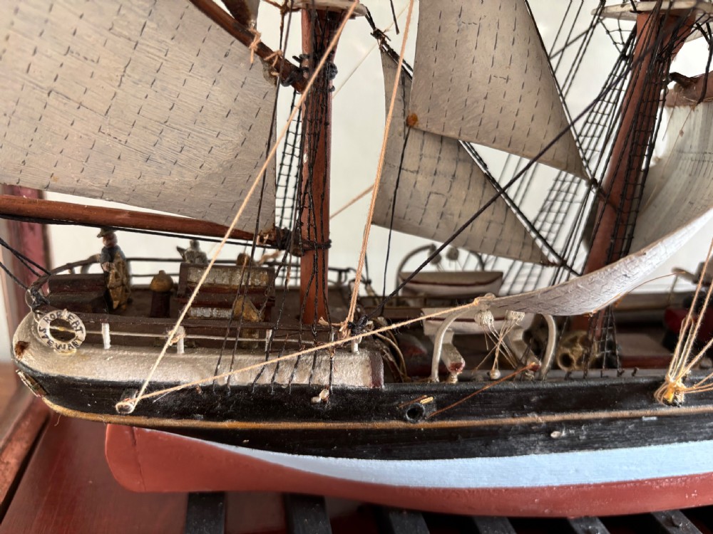 A detailed late Edwardian cased scale model of a three-masted barque sailing ship with full rigging, sails, and a painted hull. View IV