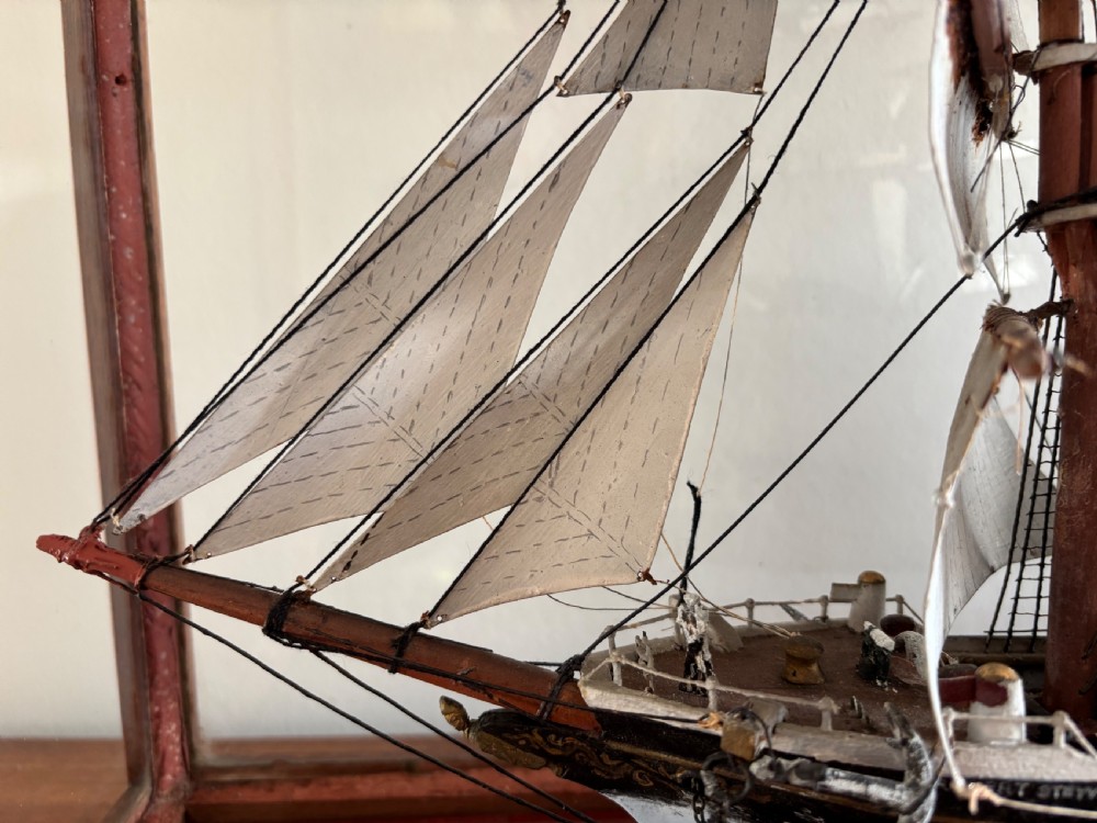 A detailed late Edwardian cased scale model of a three-masted barque sailing ship with full rigging, sails, and a painted hull. View VI