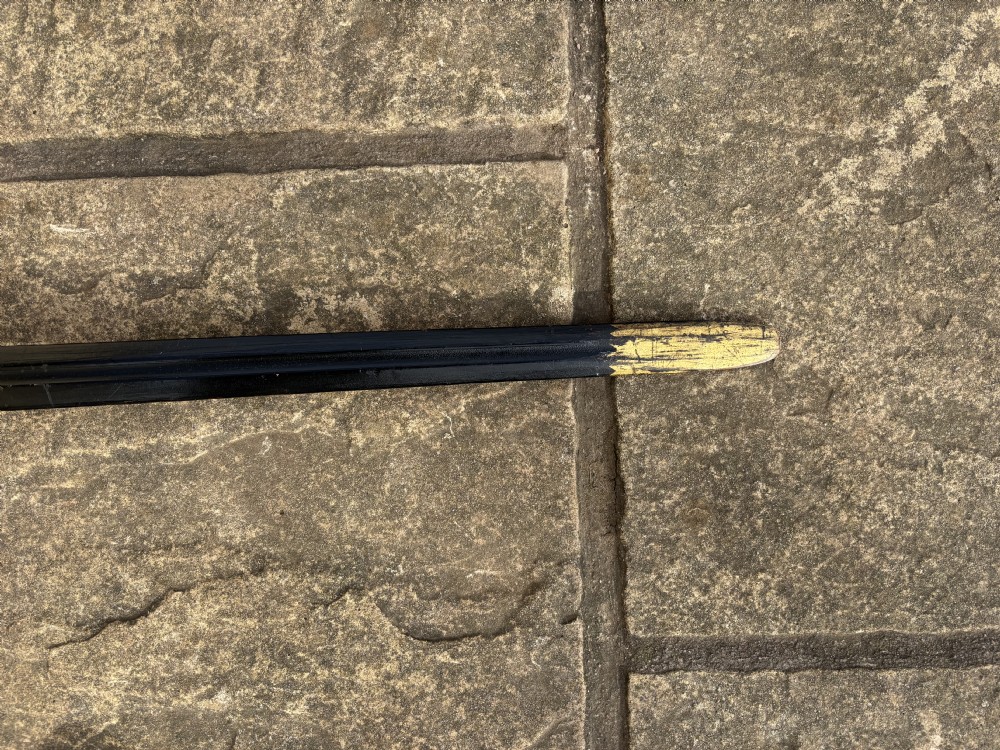 A Scottish wooden broadsword featuring a long dark blade and a basket guard lined with red leather. View IV