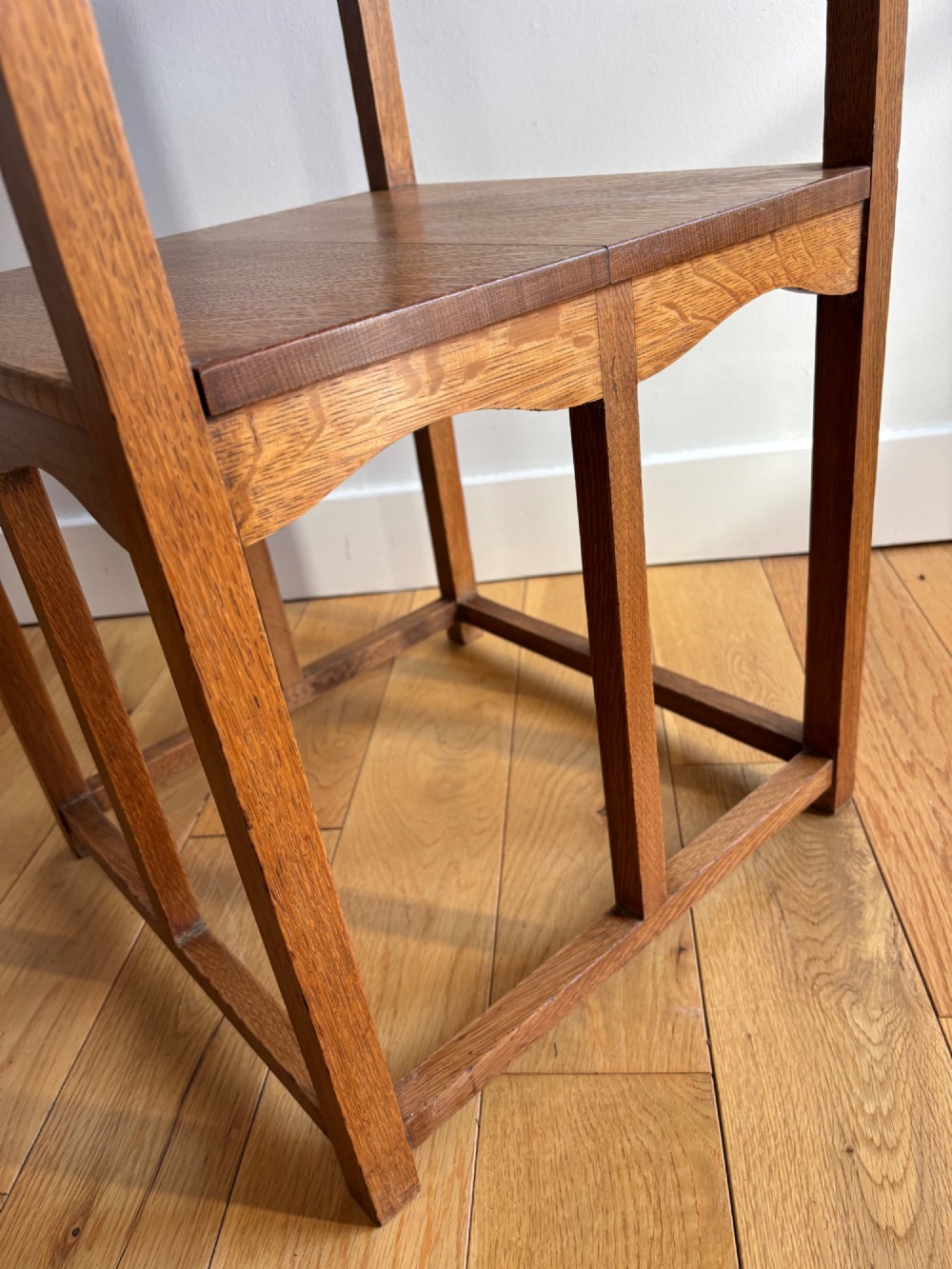An antique Arts and Crafts square oak occasional table featuring a central marquetry motif, banded inlay border, lower tier shelf, and straight legs. View III