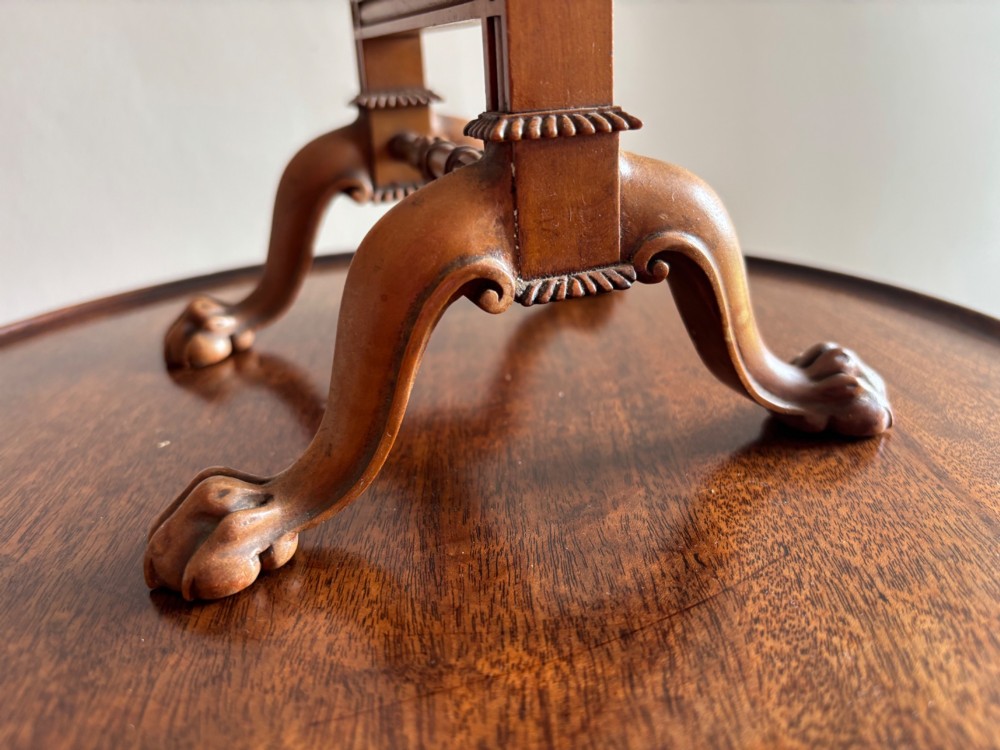 An antique Regency miniature mahogany fire screen featuring a carved frame, claw feet, and a central floral needlepoint textile panel. View IV