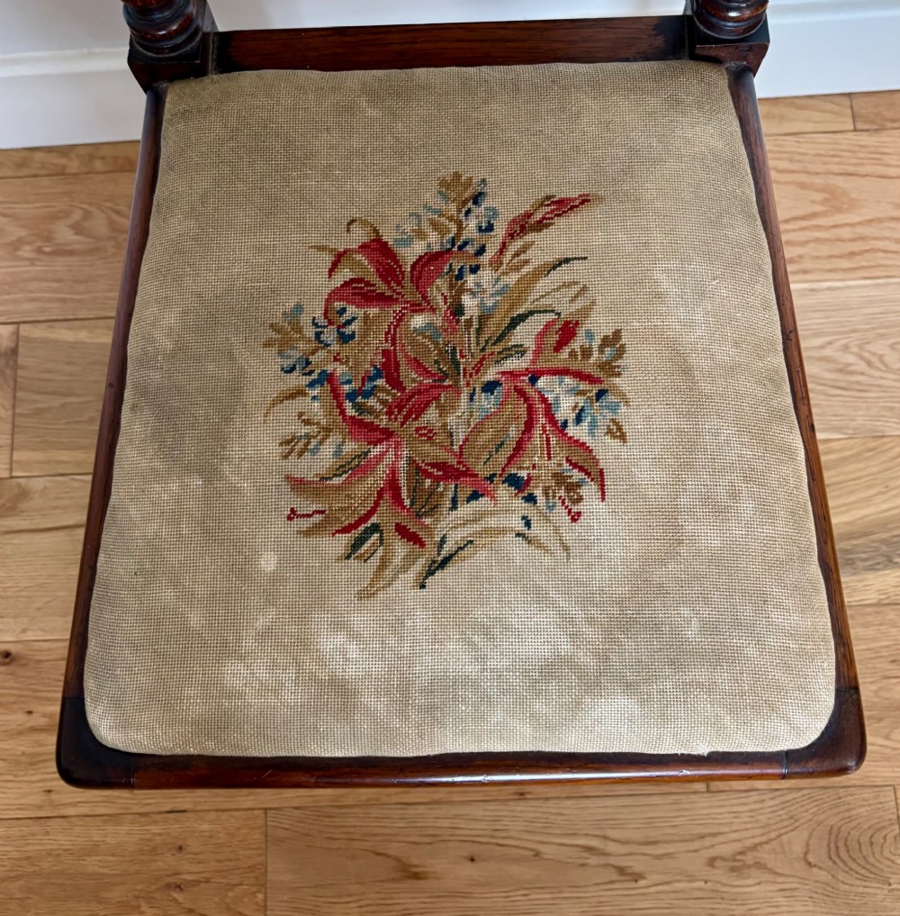 A Victorian rosewood childs chair with barley twist uprights, floral scrollwork carvings, and floral needlepoint upholstery on the seat and backrest. View III