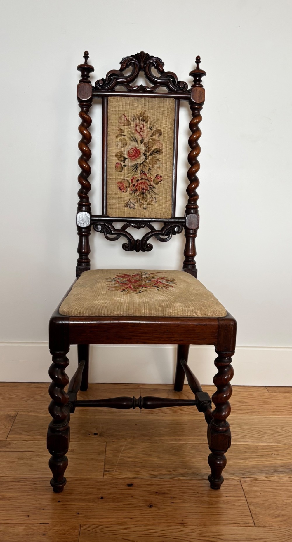 A Victorian rosewood childs chair with barley twist uprights, floral scrollwork carvings, and floral needlepoint upholstery on the seat and backrest. View IV