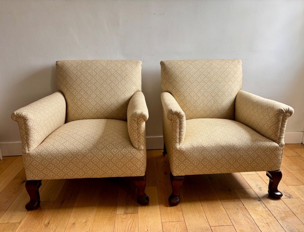 A pair of fully upholstered low-back armchairs with patterned beige fabric and dark mahogany cabriole legs. View II