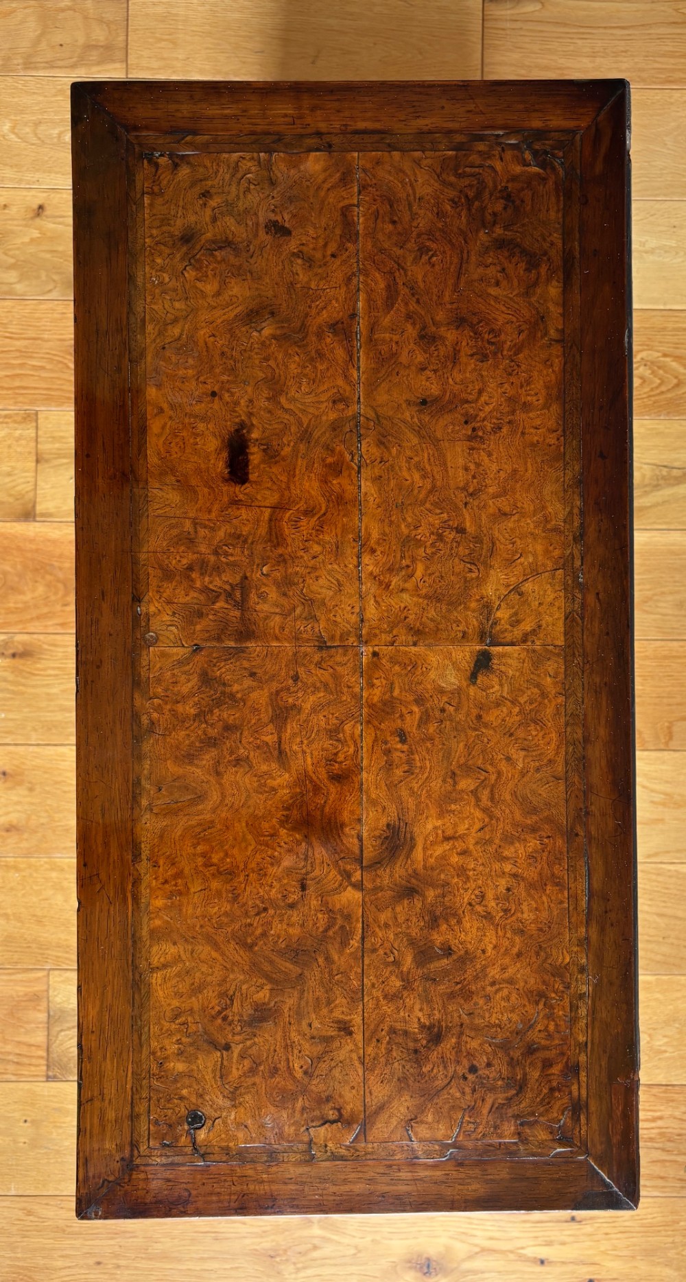 An eighteenth-century George II walnut cabinet on chest featuring arched door panels above drawers with brass handles and bracket feet. View II