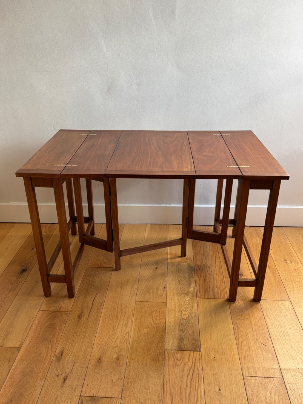 A rectangular mahogany folding table with visible brass hinges and a foldable timber leg support structure. View II