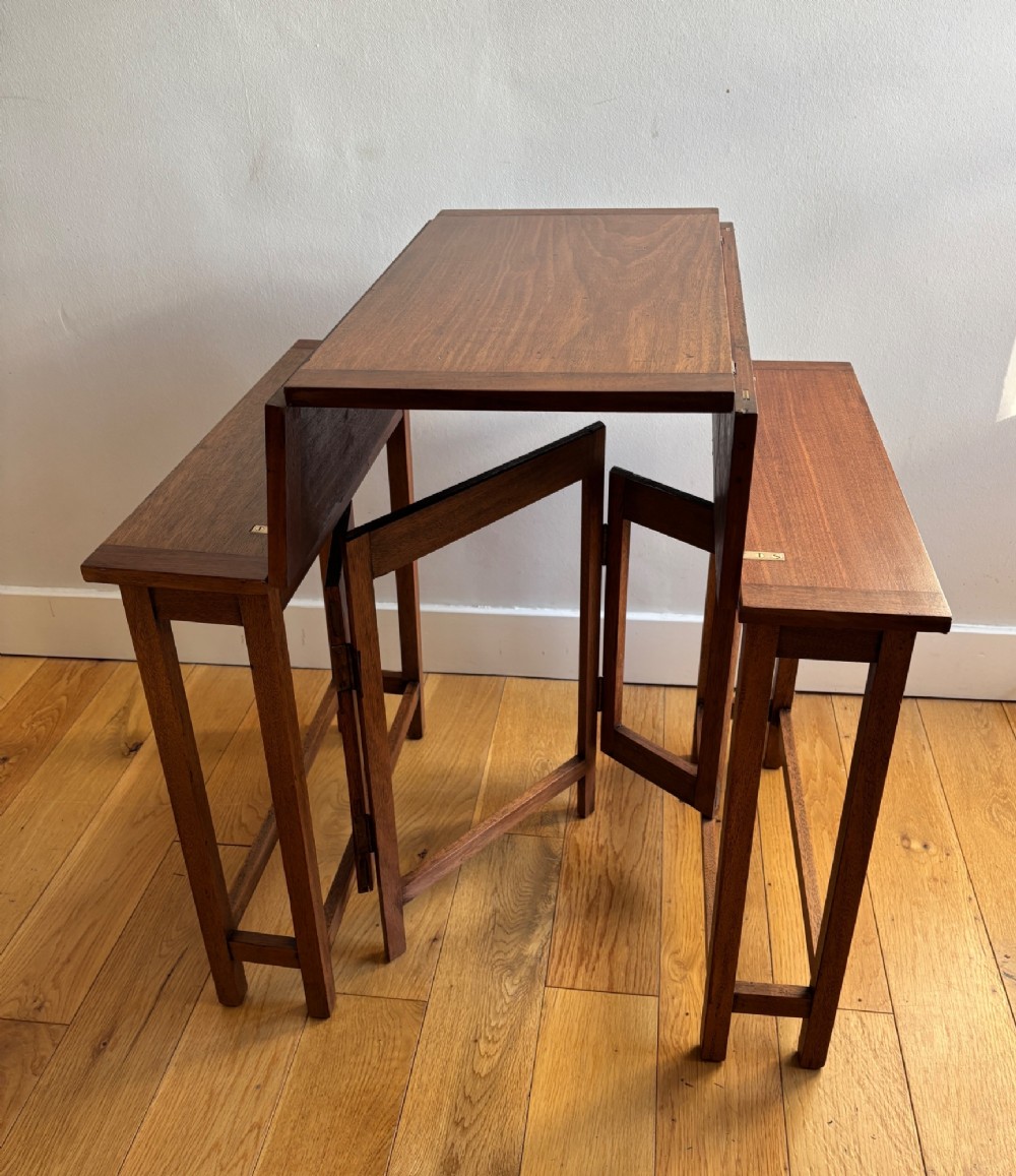 A rectangular mahogany folding table with visible brass hinges and a foldable timber leg support structure. View III