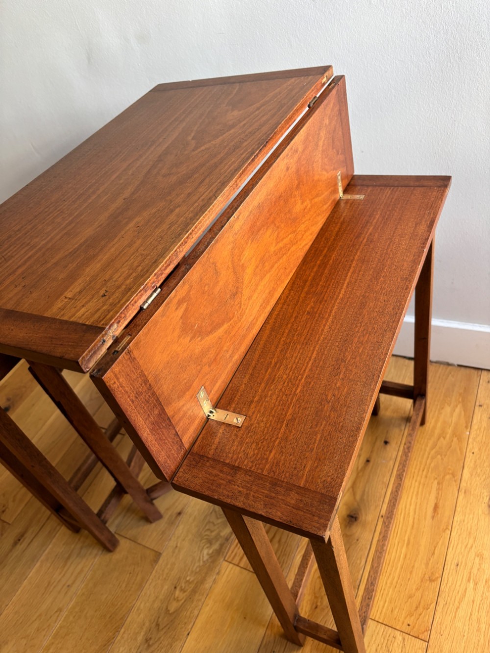 A rectangular mahogany folding table with visible brass hinges and a foldable timber leg support structure. View IV