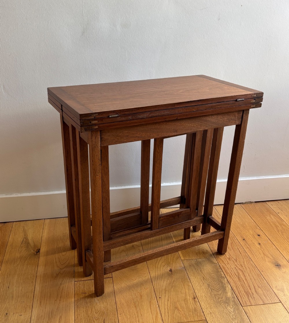 A rectangular mahogany folding table with visible brass hinges and a foldable timber leg support structure. View V