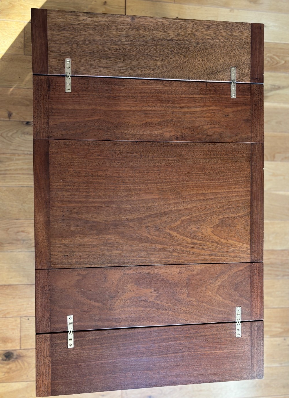 A rectangular mahogany folding table with visible brass hinges and a foldable timber leg support structure. View VII