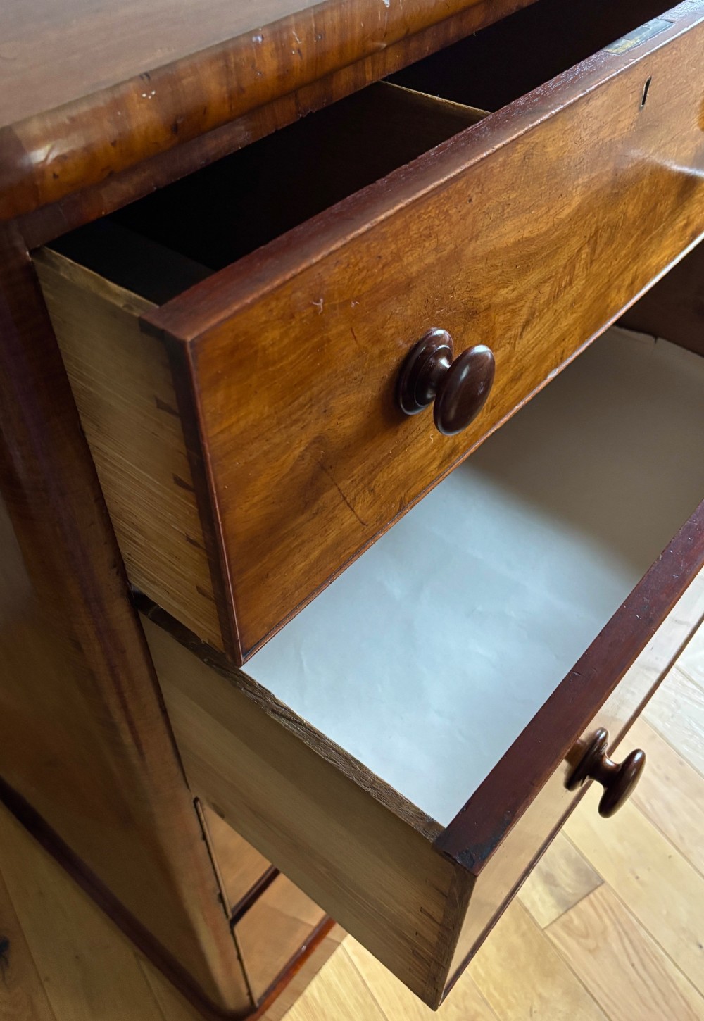 A mid-Victorian mahogany chest of drawers featuring four full-width drawers with turned wooden knobs set on a continuous plinth base. View III